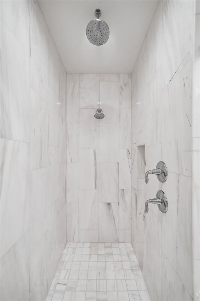 bathroom with a tile shower