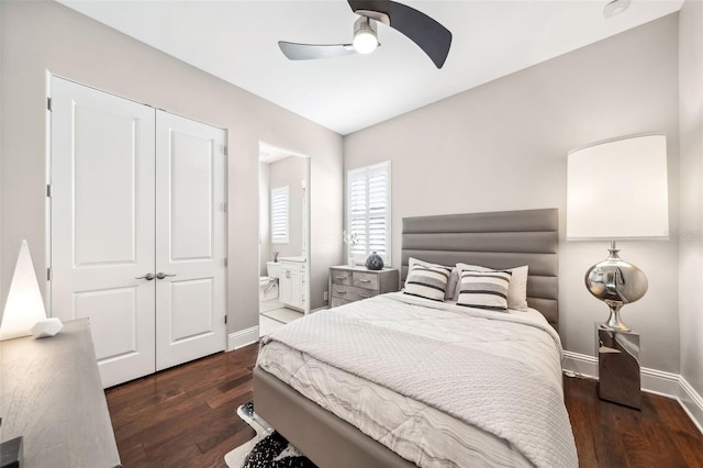 bedroom featuring baseboards, ceiling fan, wood finished floors, and ensuite bathroom