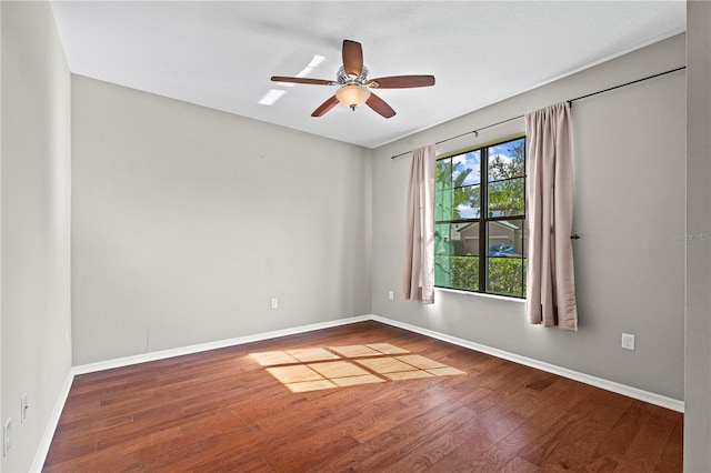 unfurnished room with baseboards, ceiling fan, and wood finished floors