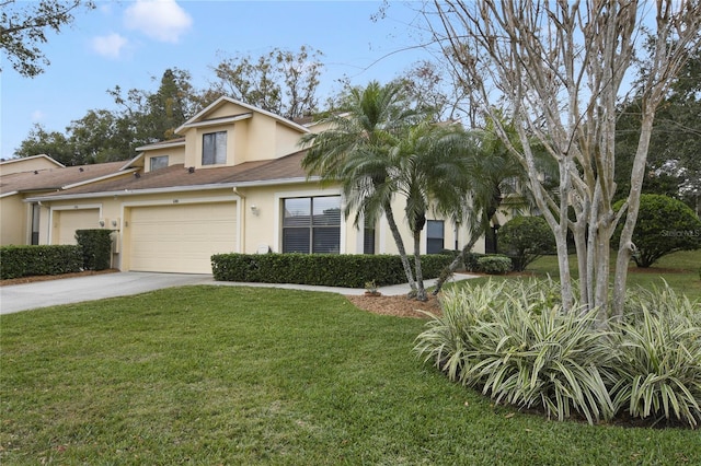 view of front of home with stucco siding, an attached garage, driveway, and a front lawn