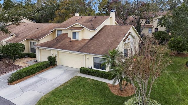 traditional-style house with a garage, a chimney, roof with shingles, and stucco siding