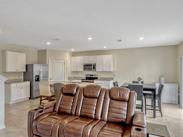 3033 Beau Loop, Tavares, FL 32778 - living area featuring light tile patterned flooring, visible vents, and recessed lighting