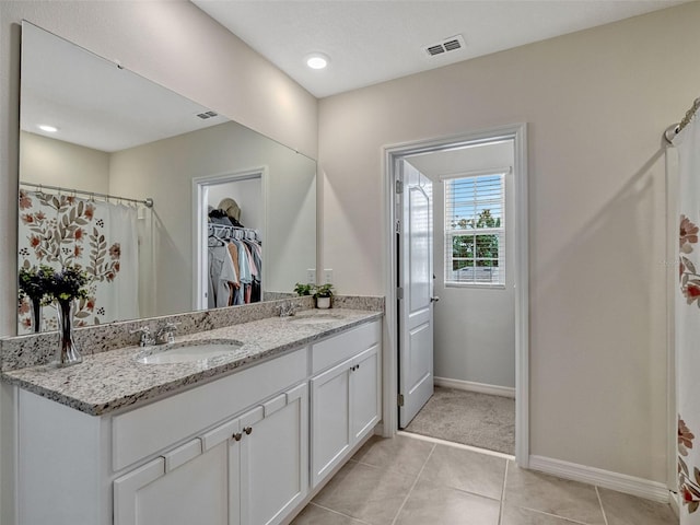 3033 Beau Loop, Tavares, FL 32778 - full bathroom with a sink, a walk in closet, tile patterned floors, and visible vents