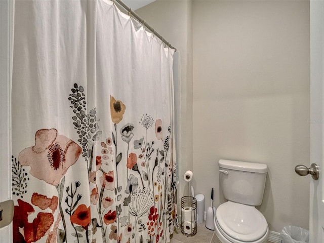 3033 Beau Loop, Tavares, FL 32778 - full bathroom featuring toilet, baseboards, a shower with shower curtain, and tile patterned flooring