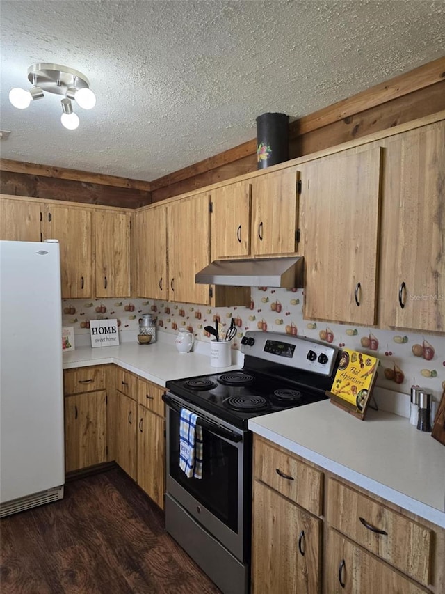 kitchen with a textured ceiling, stainless steel range with electric cooktop, light countertops, freestanding refrigerator, and under cabinet range hood
