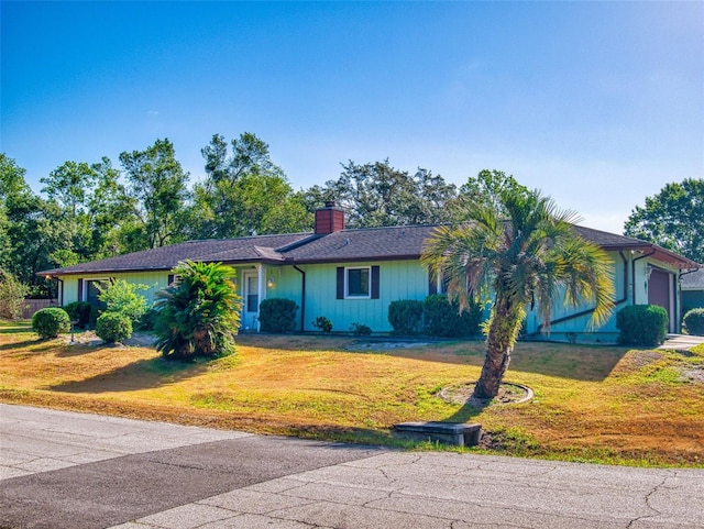 1872 N Akron Dr, Deltona, FL 32738 - ranch-style home featuring a chimney, a front yard, and an attached garage