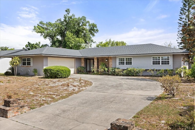 ranch-style house with concrete driveway and an attached garage