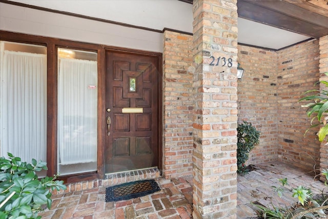 property entrance featuring brick siding