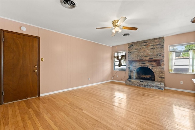unfurnished living room with a ceiling fan, baseboards, visible vents, and light wood-style floors