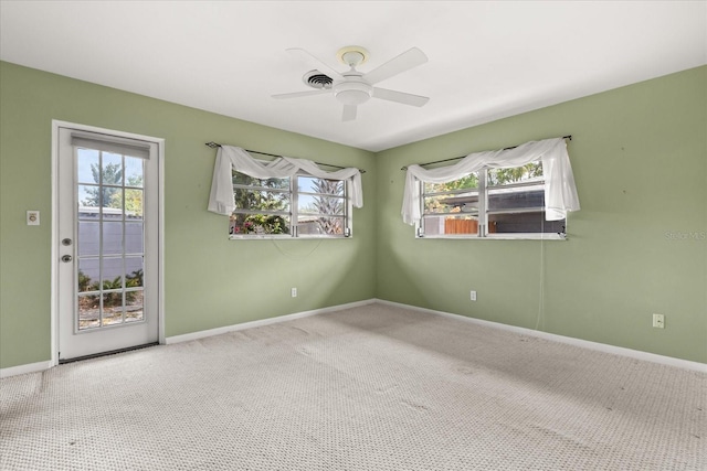 spare room featuring carpet floors, baseboards, and a ceiling fan