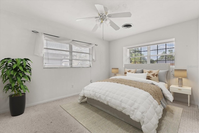 bedroom with baseboards, a ceiling fan, carpet flooring, and visible vents