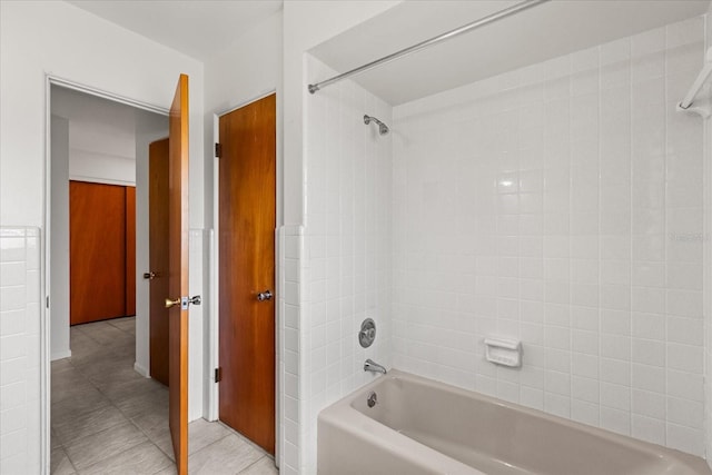 bathroom featuring tile patterned floors and bathing tub / shower combination