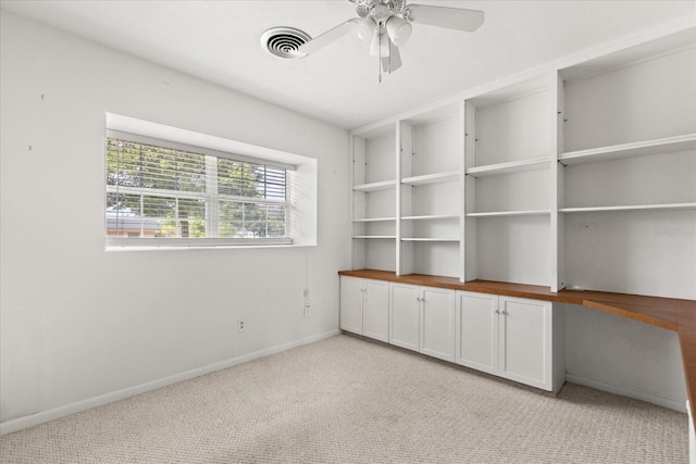 unfurnished room with baseboards, ceiling fan, light carpet, and visible vents
