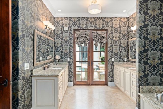 9730 Lounsberry Cir, Golden Oak, FL 32836 - full bath with wallpapered walls, ornamental molding, two vanities, french doors, and baseboards