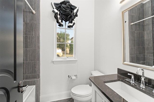 9730 Lounsberry Cir, Golden Oak, FL 32836 - bathroom featuring toilet, a shower, baseboards, and vanity