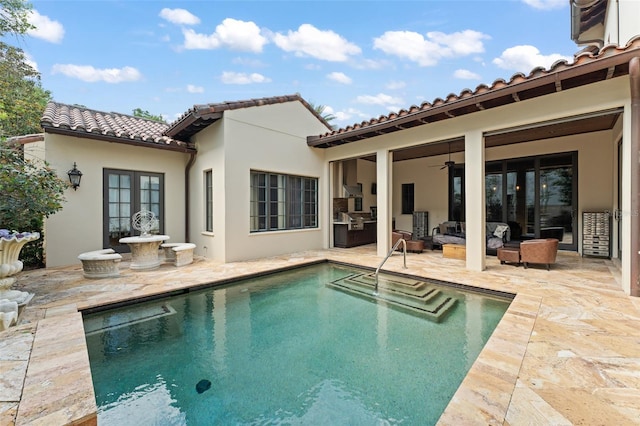 9730 Lounsberry Cir, Golden Oak, FL 32836 - back of property with an outdoor hangout area, a patio area, a tiled roof, and an outdoor pool