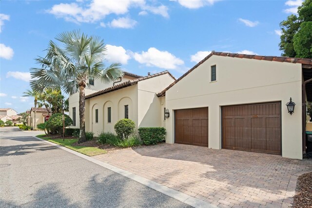 9730 Lounsberry Cir, Golden Oak, FL 32836 - mediterranean / spanish home featuring decorative driveway, stucco siding, and a garage