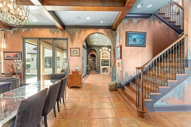 9730 Lounsberry Cir, Golden Oak, FL 32836 - foyer entrance featuring arched walkways, stairs, beamed ceiling, stone tile floors, and a chandelier