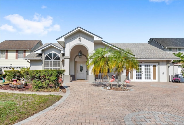 view of front of house with french doors and stucco siding