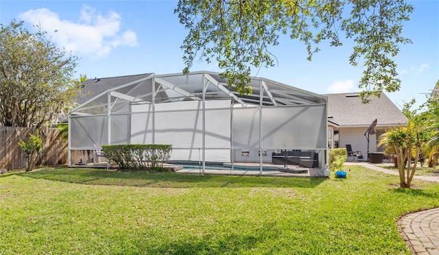exterior space featuring fence, a fenced in pool, a lawn, and a lanai