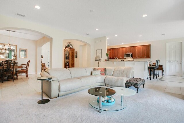 18108 Bellezza Dr, Orlando, FL 32820 - living area with visible vents, arched walkways, light tile patterned floors, and recessed lighting