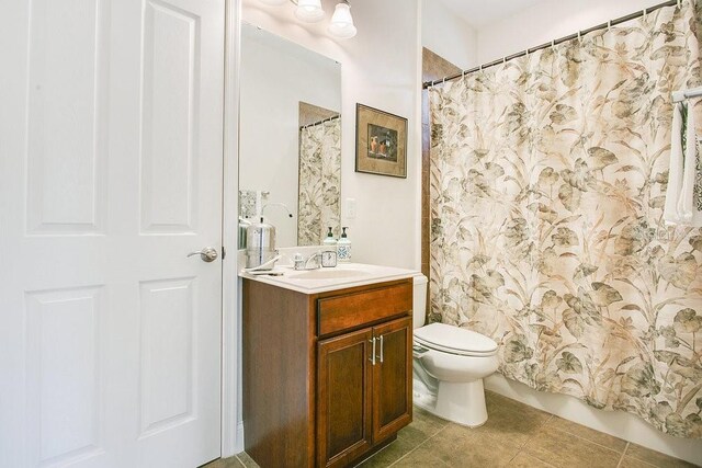 18108 Bellezza Dr, Orlando, FL 32820 - bathroom with vanity, tile patterned floors, and toilet