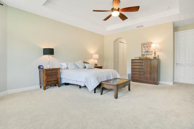 18108 Bellezza Dr, Orlando, FL 32820 - carpeted bedroom with visible vents, crown molding, baseboards, a raised ceiling, and arched walkways
