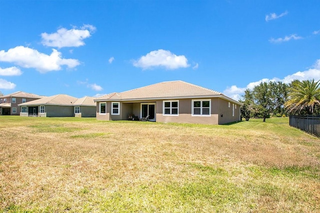 18108 Bellezza Dr, Orlando, FL 32820 - rear view of property with a yard, fence, and stucco siding