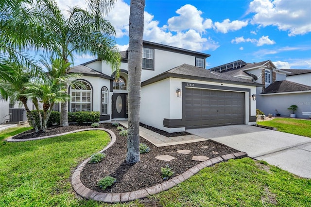 view of front of property featuring an attached garage, stucco siding, a front yard, and concrete driveway