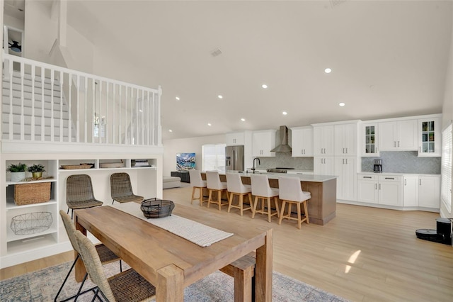 dining area featuring recessed lighting and light wood-style flooring