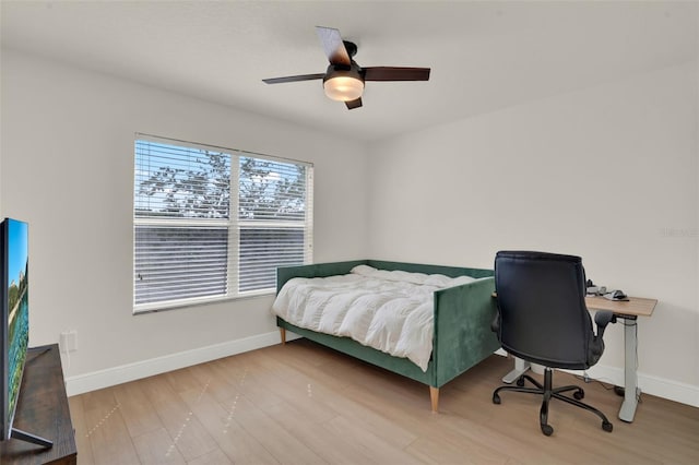bedroom with baseboards, ceiling fan, and wood finished floors