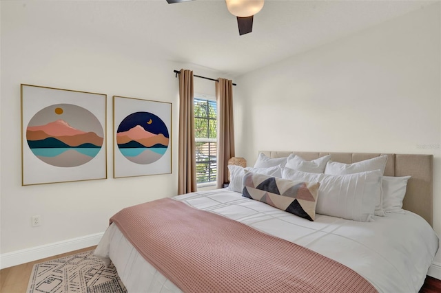 bedroom featuring baseboards, ceiling fan, and wood finished floors