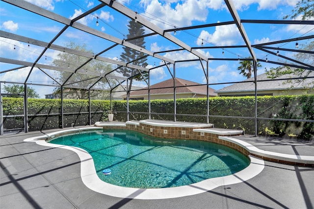 view of pool with a fenced in pool, an outdoor hot tub, a lanai, and a patio area