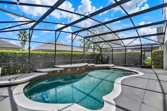 view of swimming pool with a fenced in pool, a lanai, an in ground hot tub, and a patio area