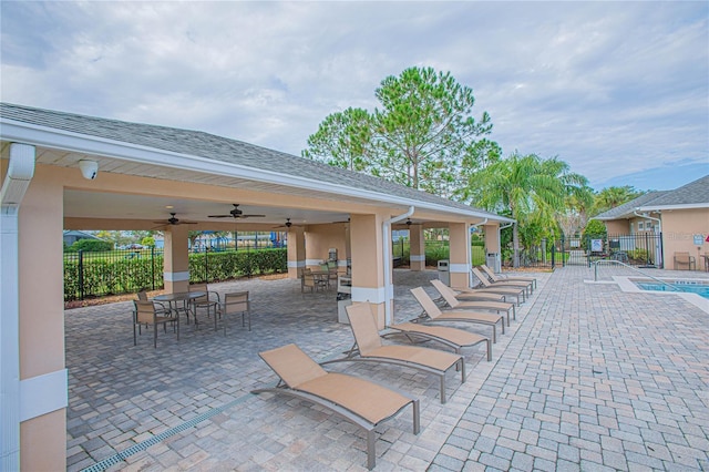 view of patio / terrace with ceiling fan, fence, and outdoor dining space