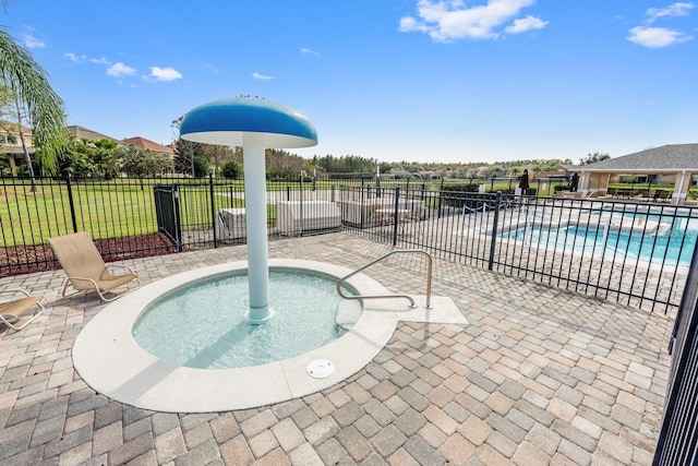 pool featuring a lawn, a patio, and fence