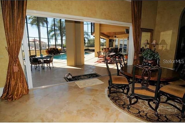 interior space with a lanai, outdoor dining area, and an outdoor pool