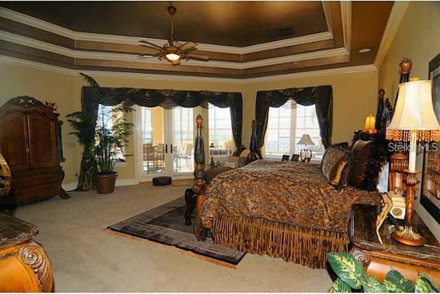 bedroom with crown molding, access to exterior, a tray ceiling, a ceiling fan, and carpet
