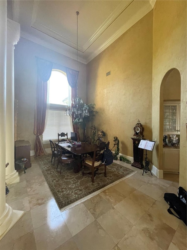 dining area with arched walkways and ornamental molding