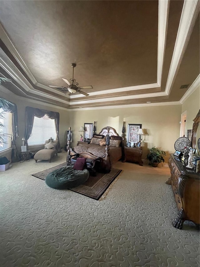 bedroom featuring a raised ceiling, ornamental molding, and carpet floors