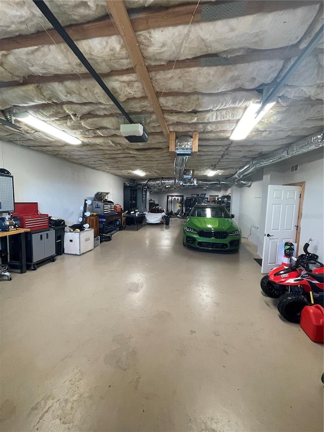garage with visible vents and a garage door opener