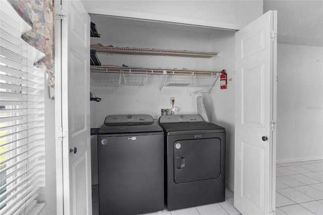 3137 Timucua Cir, Orlando, FL 32837 - washroom featuring washing machine and dryer and light tile patterned floors