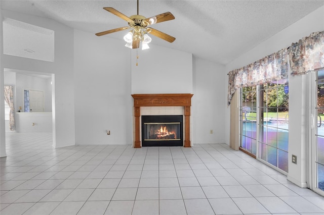 3137 Timucua Cir, Orlando, FL 32837 - unfurnished living room featuring vaulted ceiling, a textured ceiling, a ceiling fan, a tile fireplace, and light tile patterned floors