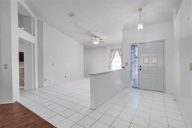 3137 Timucua Cir, Orlando, FL 32837 - foyer featuring a ceiling fan, a textured ceiling, and light tile patterned floors