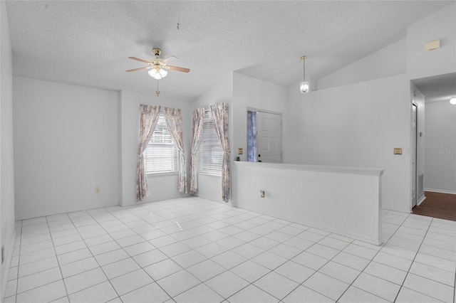 3137 Timucua Cir, Orlando, FL 32837 - spare room with a ceiling fan, light tile patterned floors, a textured ceiling, and lofted ceiling