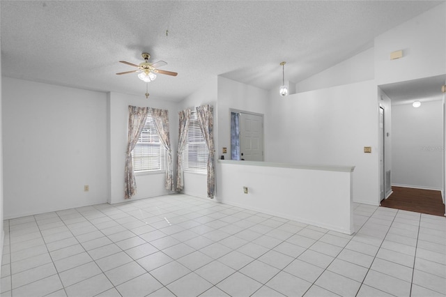 3137 Timucua Cir, Orlando, FL 32837 - spare room with a ceiling fan, a textured ceiling, light tile patterned floors, and lofted ceiling