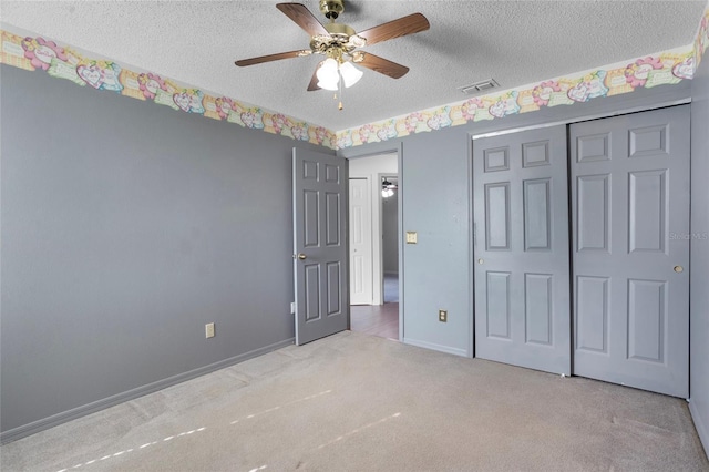 3137 Timucua Cir, Orlando, FL 32837 - unfurnished bedroom with a textured ceiling, carpet floors, a closet, and ceiling fan