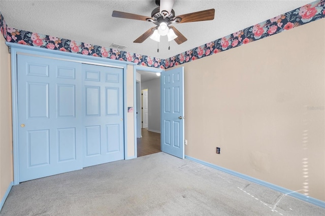 3137 Timucua Cir, Orlando, FL 32837 - unfurnished bedroom featuring carpet floors, a textured ceiling, a closet, and ceiling fan