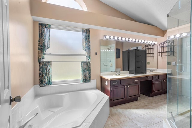 3137 Timucua Cir, Orlando, FL 32837 - full bath with a shower stall, double vanity, vaulted ceiling, a garden tub, and tile patterned flooring