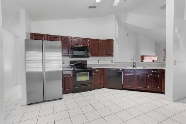 3137 Timucua Cir, Orlando, FL 32837 - kitchen with black appliances, light countertops, light tile patterned flooring, high vaulted ceiling, and reddish brown cabinets